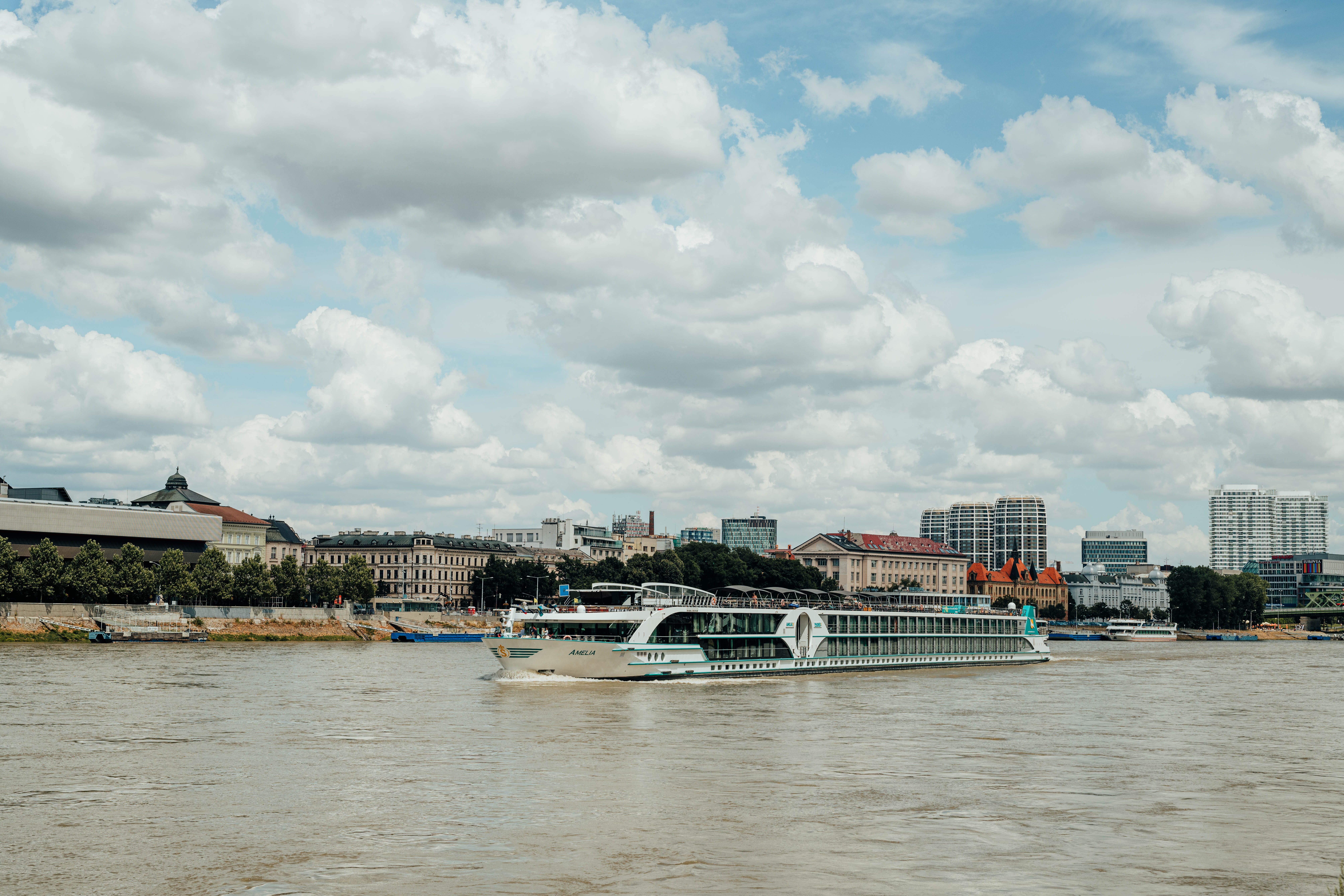 River cruise ship on the Danube River against the Bratislava skyline in autumn