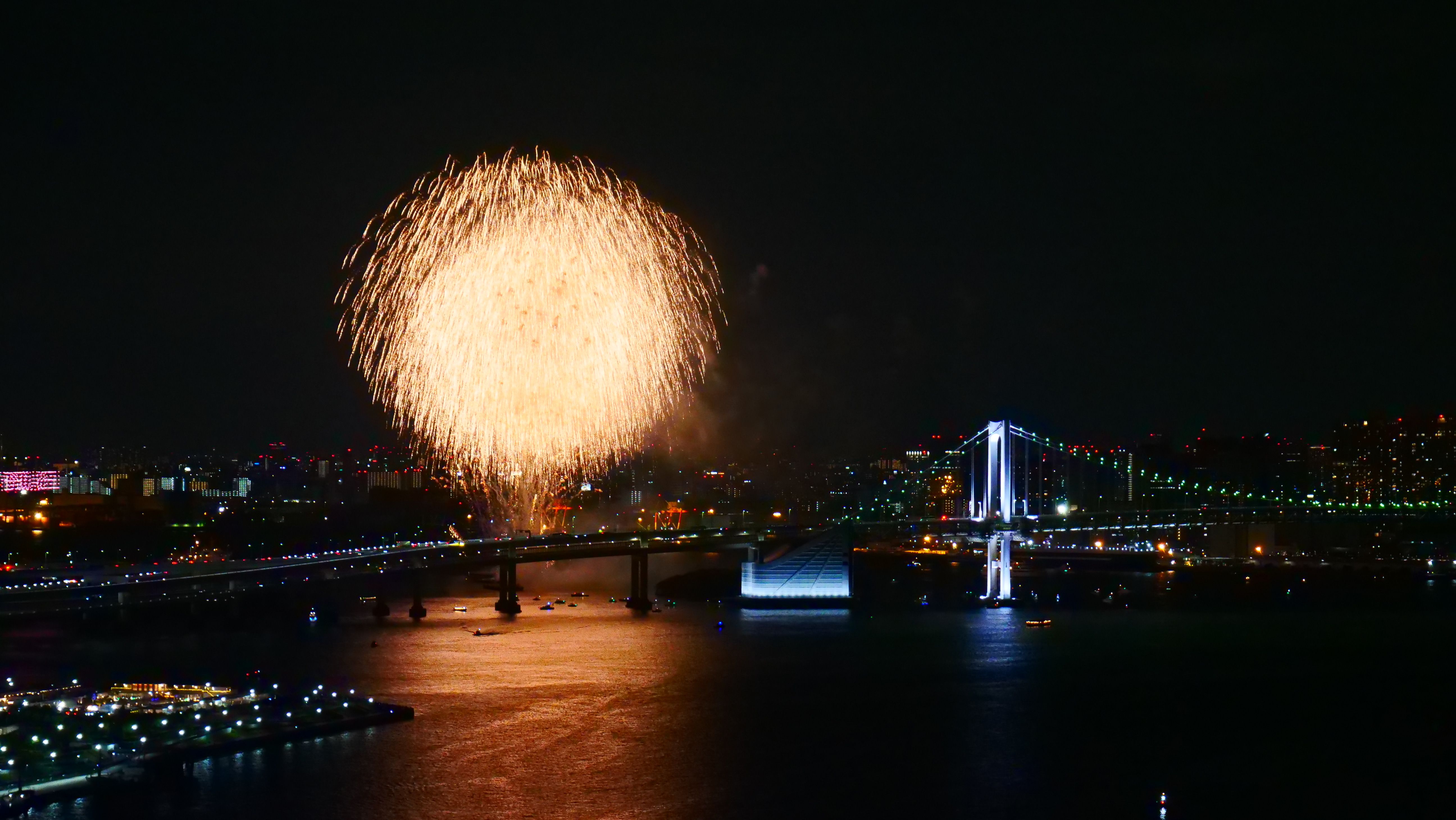 Spectacular fireworks over Rainbow Bridge in Tokyo Bay Japan during a New Year's Eve celebration